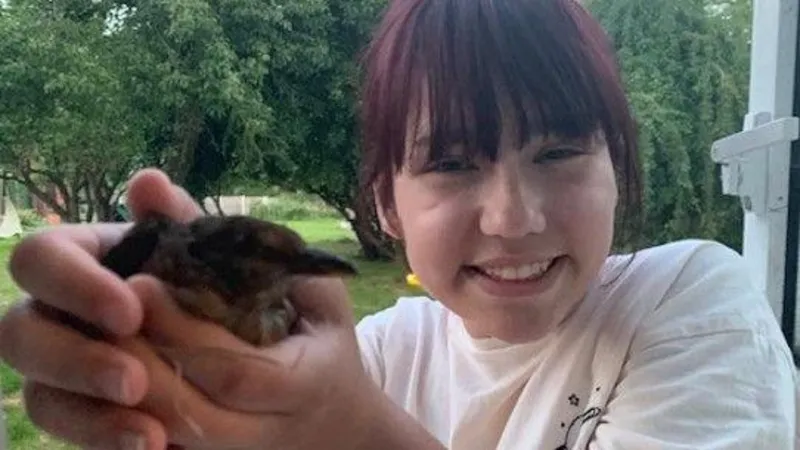 Elise Sebastian holding a small bird
