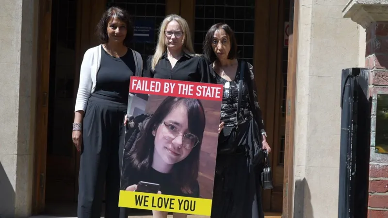 Victoria Sebastian and supporters holding a poster of Elise