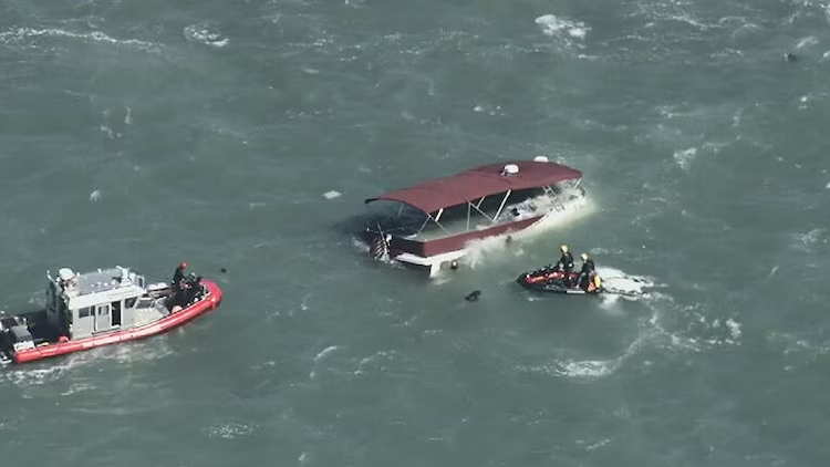 Rescue boats surround the capsized Volare near Alcatraz Island