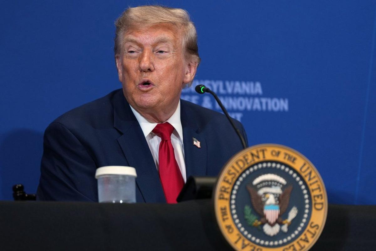 President Donald Trump speaks at a podium with the presidential seal